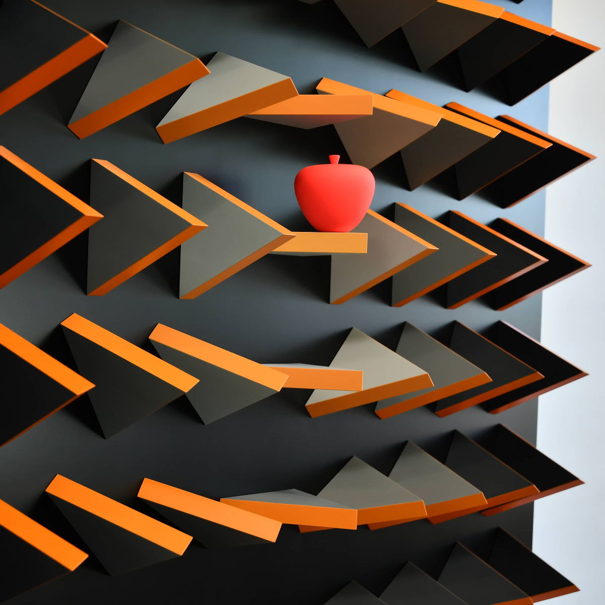 Red apple on a geometric shelf design with orange and gray shapes.