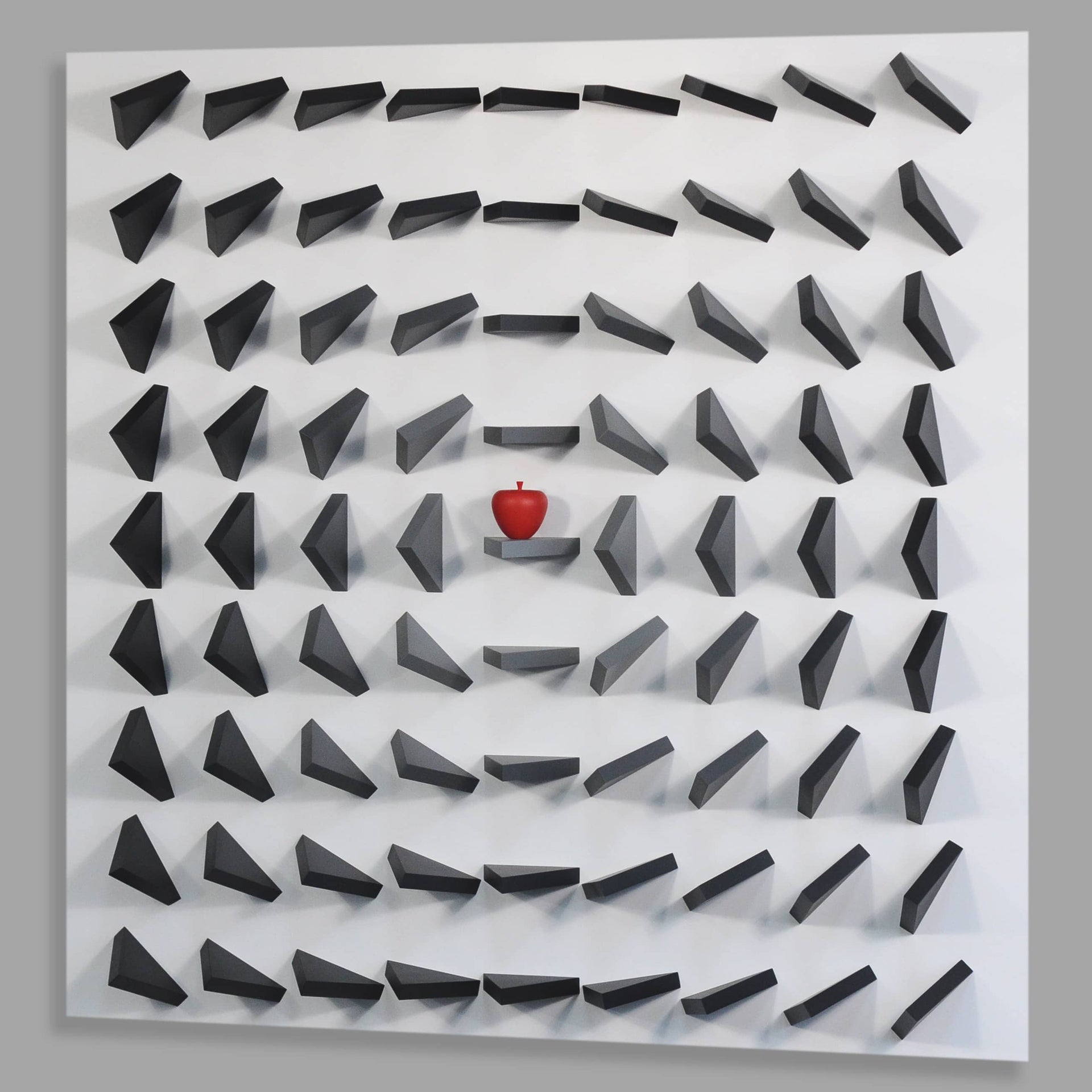 Labyrinthine wall art with a red ball at the center on a gray background