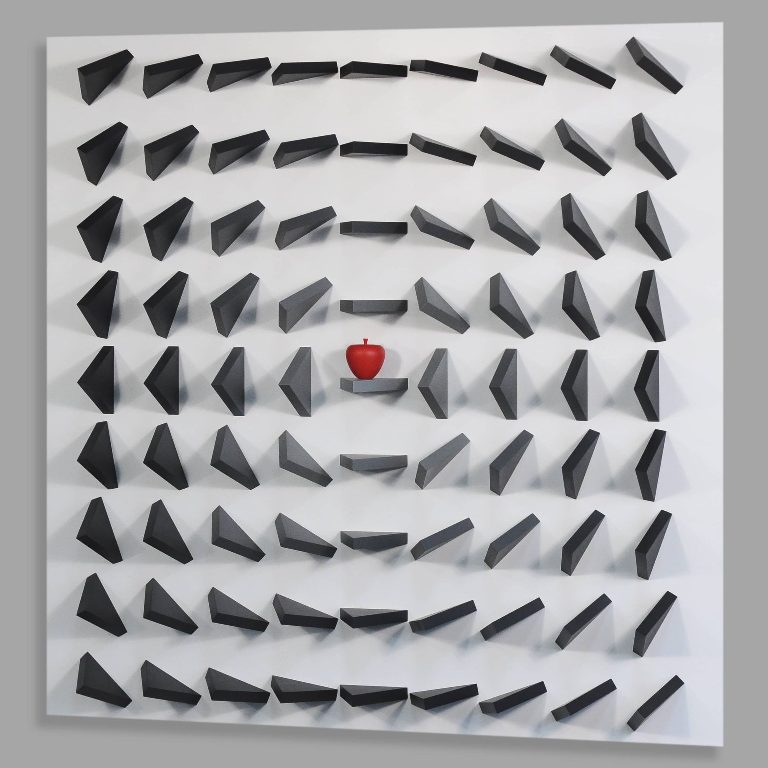 Labyrinthine wall art with a red ball at the center on a gray background