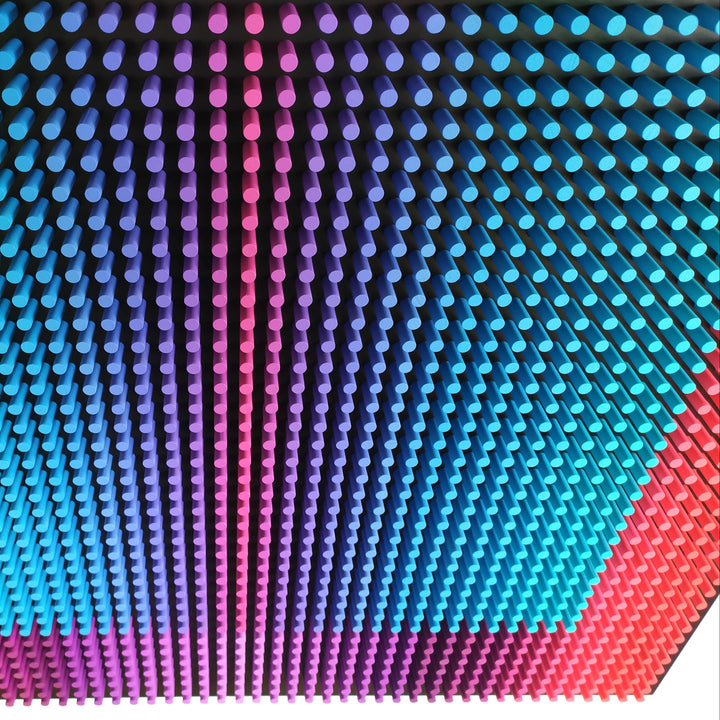 Close-up of a colorful, textured surface with a gradient from red to blue.