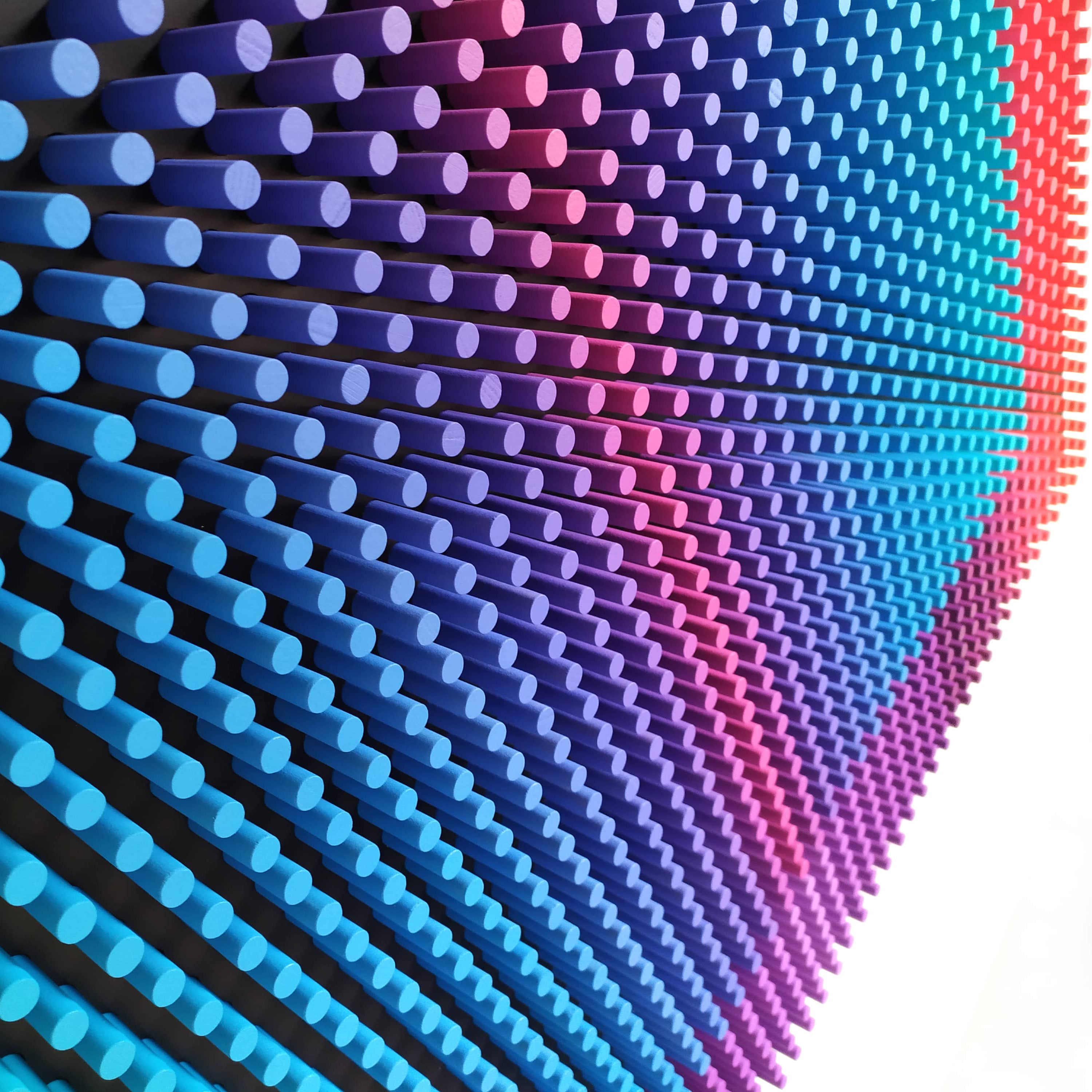 Wall with blue and pink cylindrical lights arranged in a pattern